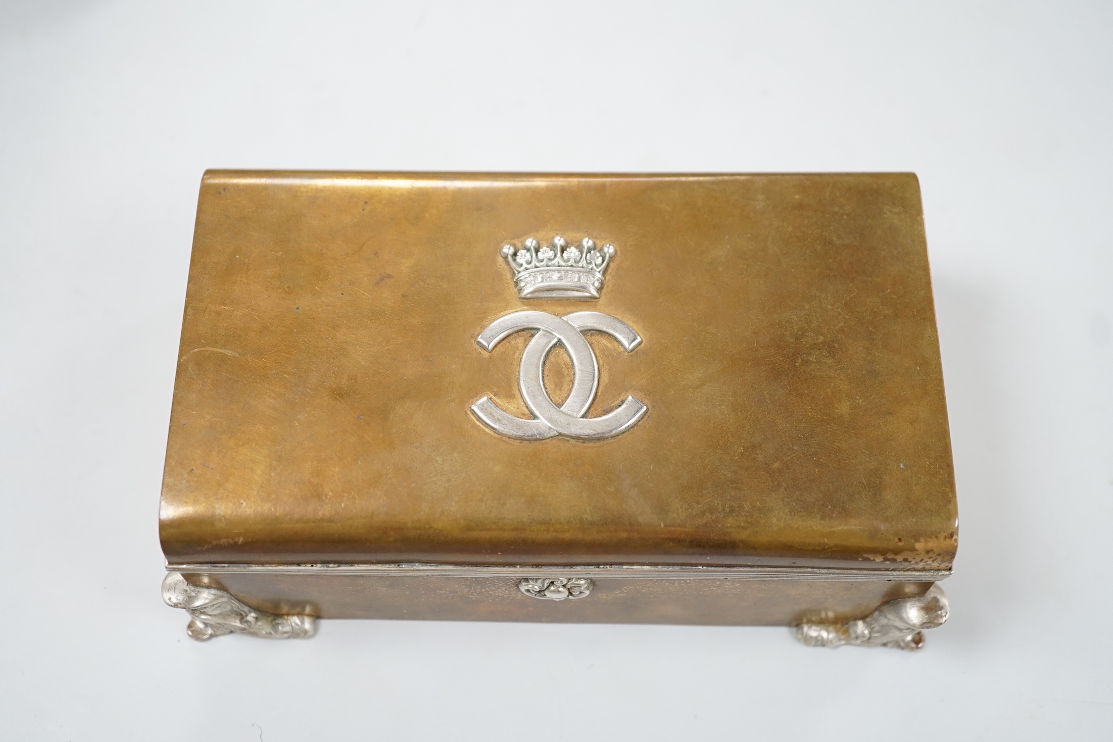 An unusual late Victorian silver mounted brass rectangular cigarette box, with applied monogram, Alfred Fuller, London, 1885, 16.4cm.